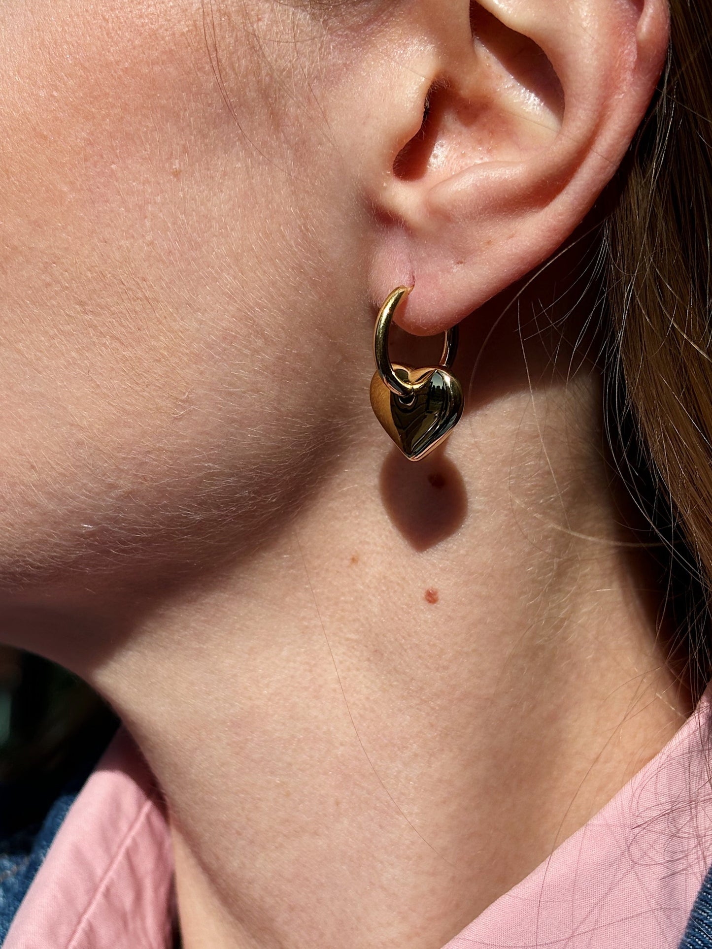 Hoop earrings with hearts pendants