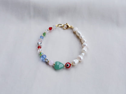 Pearl bracelet with evil eye and heart beads