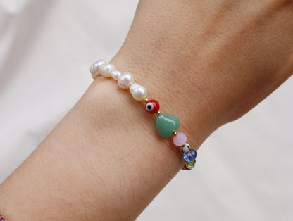 Pearl bracelet with evil eye and heart beads