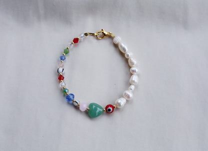 Pearl bracelet with evil eye and heart beads